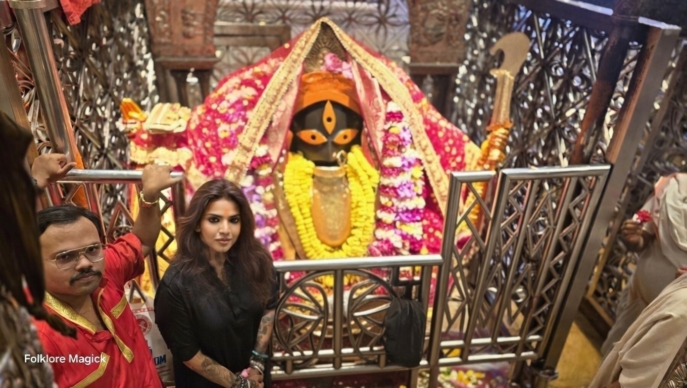 Meenakshii at the Shiv Kali Manasa Temple at Maniktala, Habra, 24 Parganas (N) — standing before the Kali deity with the temple priest in red beside her